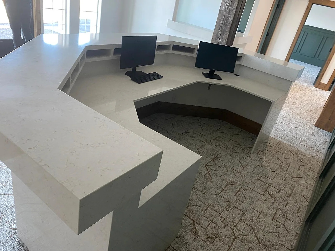 The same curved reception desk finished with a quartz worktop